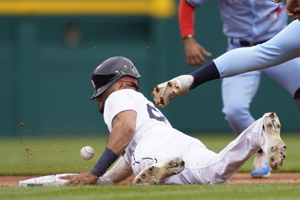 Detroit Tigers' Victor Reyes safely steals second as Toronto Blue Jays shortstop Bo Bichette, right, loses control of the throw during the first inning of a baseball game, Saturday, June 11, 2022, in Detroit. (AP Photo/Carlos Osorio)