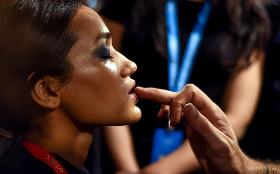 An Indian model gets ready with the makeup and hair backstage crew before the show begins at the LakmÃ© Fashion Week (LFW) Summer Resort 2019, in Mumbai on January 31, 2019. (Photo by Sujit JAISWAL / AFP)        (Photo credit should read SUJIT JAISWAL/AFP/Getty Images)