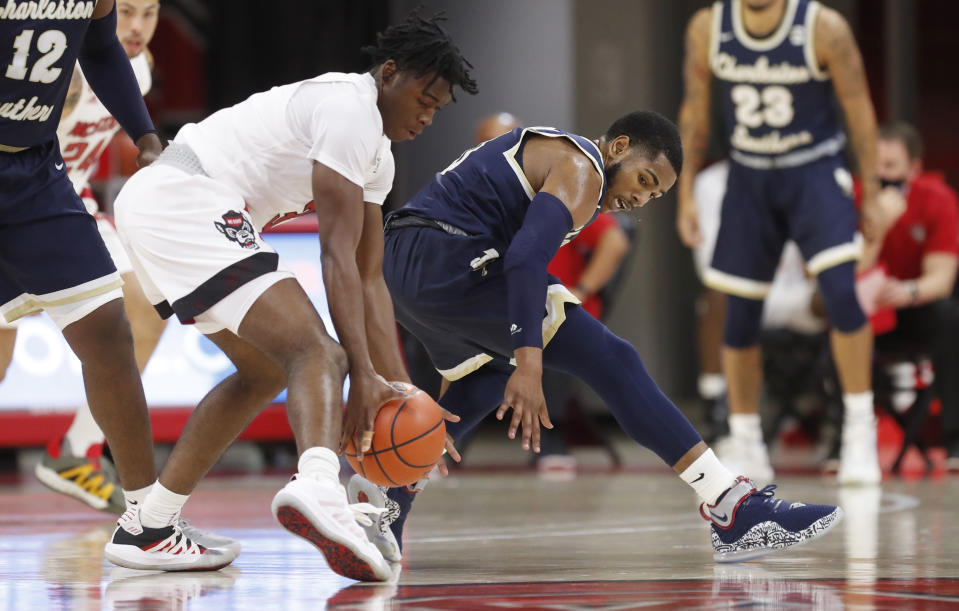 North Carolina State's Cam Hayes (3) steals the ball from Charleston Southern's Travis Anderson (0) during the first half in an NCAA college basketball game in Raleigh, N.C., Wednesday, Nov. 25, 2020. (Ethan Hyman/The News & Observer via AP)