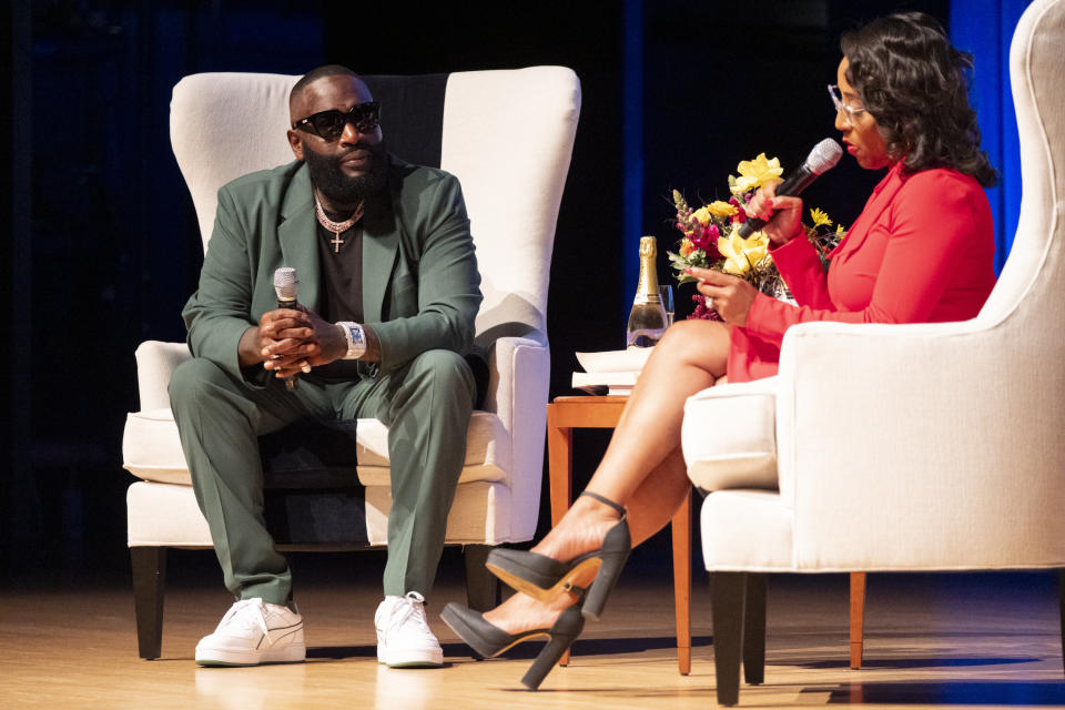 Rick Ross talks with Professor Moraima "Mo" Ivory during the final night of a Gerogia State University class called Legal Life of Rick Ross in Atlanta on Tuesday, Nov. 7, 2023. (AP Photo/Ben Gray)