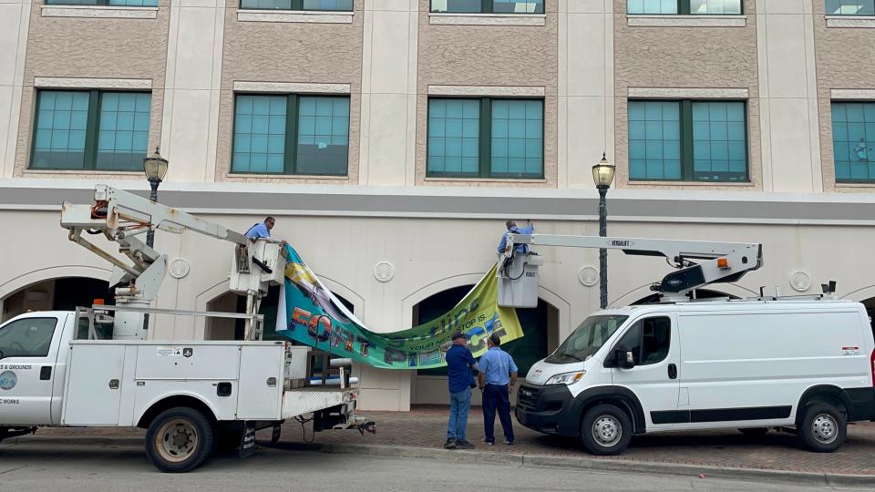 City public works employees hung Brightline banners on the City Hall parking garage in downtown Fort Pierce on Wednesday, Dec. 13, 2023.