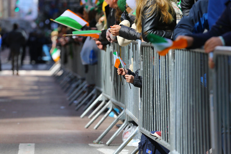 A youngster holds two flags of Ireland through the barricade during the St. Patrick's Day Parade, March 16, 2019, in New York. (Photo: Gordon Donovan/Yahoo News)
