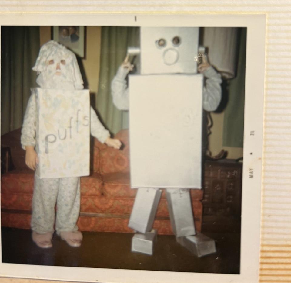 Kathy Arbuckle's children, Amy (left) and Jim (right), dress up as a Puffs tissue box and robot for Halloween 1970.