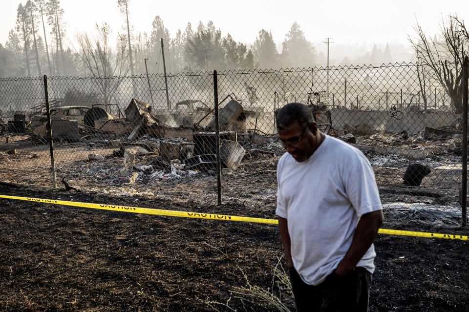 Dave Rodgers pauses while surveying his home, destroyed by the Mill Fire, on Saturday, Sept. 3, 2022, in Weed, Calif. Rodgers, who lived in the house his entire life, was able to take an elderly neighbor with him as he fled the fast-moving blaze but has not been able to find his two dogs that were left behind. (AP Photo/Noah Berger)
