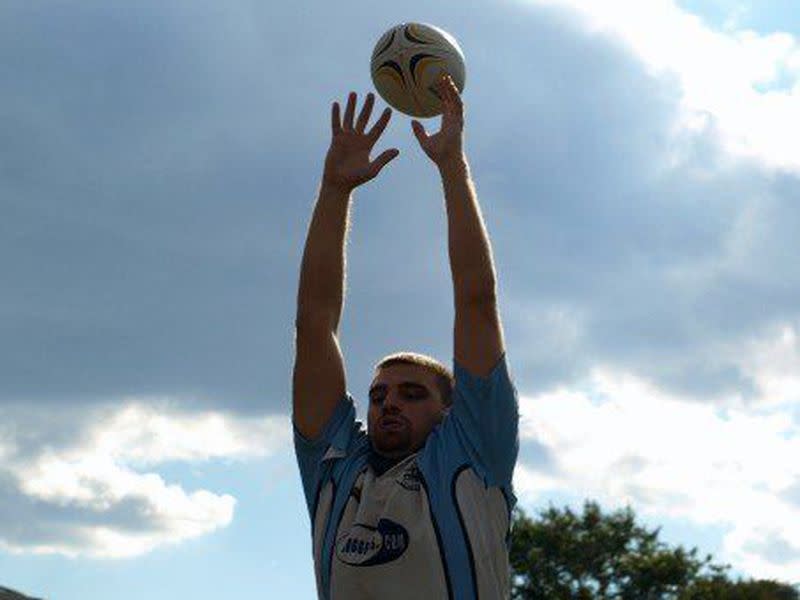 Yakovenko stretches atop the line-out at a Columbia University rugby match.