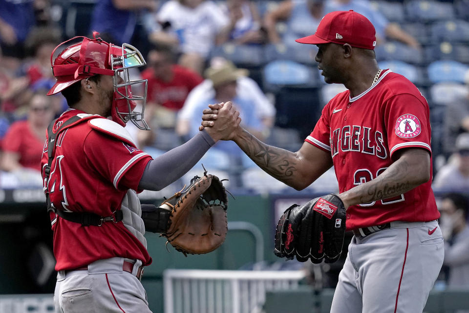 Los Angeles Angels catcher Kurt Suzuki and relief pitcher Raisel Iglesias celebrate after their baseball game game against the Kansas City Royals Wednesday, July 27, 2022, in Kansas City, Mo. The Angels won 4-0. (AP Photo/Charlie Riedel)