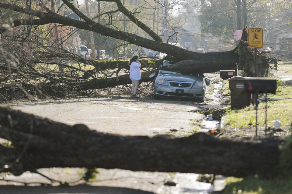 A resident surveys the damage done to her car Saturday, March 25, 2023 in Amory, Miss. Emergency officials in Mississippi say several people have been killed by tornadoes that tore through the state on Friday night, destroying buildings and knocking out power as severe weather produced hail the size of golf balls moved through several southern states (Thomas Wells/The Northeast Mississippi Daily Journal via AP)