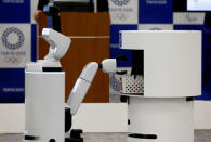 Toyota's HSR (Human Support Robot) (L) picks up a basket from DSR (Delivery Support Robot) at a demonstration of Tokyo 2020 Robot Project for Tokyo 2020 Olympic Games in Tokyo, Japan, March 15, 2019. REUTERS/Kim Kyung-hoon