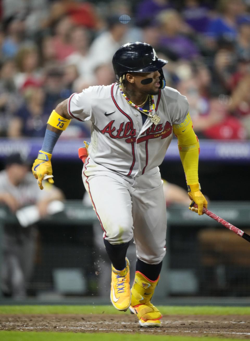 Atlanta Braves' Ronald Acuña Jr. breaks from the batter's box after hitting a single off Colorado Rockies relief pitcher Justin Lawrence during the ninth inning of a baseball game Wednesday, Aug. 30, 2023, in Denver. (AP Photo/David Zalubowski)