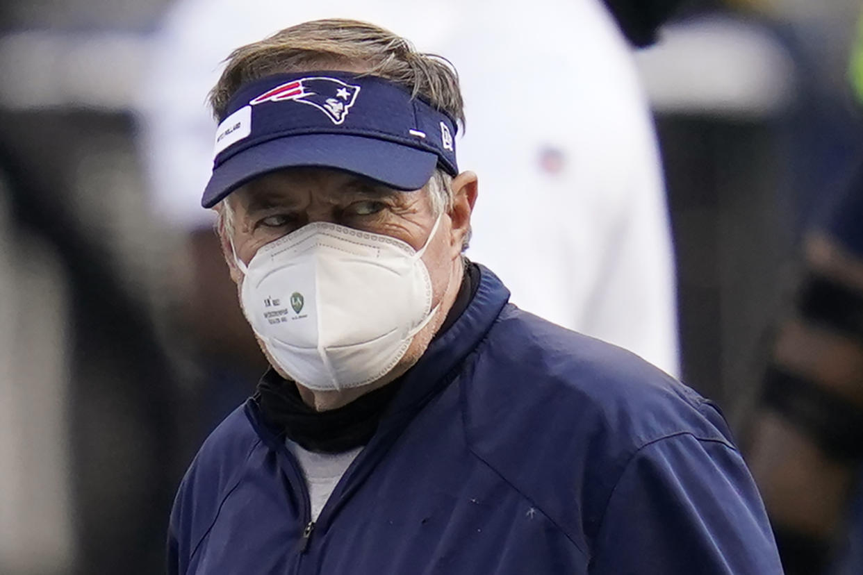 New England Patriots head coach Bill Belichick wears a mask as he walks on the field before an NFL football game against the Seattle Seahawks, Sunday, Sept. 20, 2020, in Seattle. (AP Photo/Elaine Thompson)