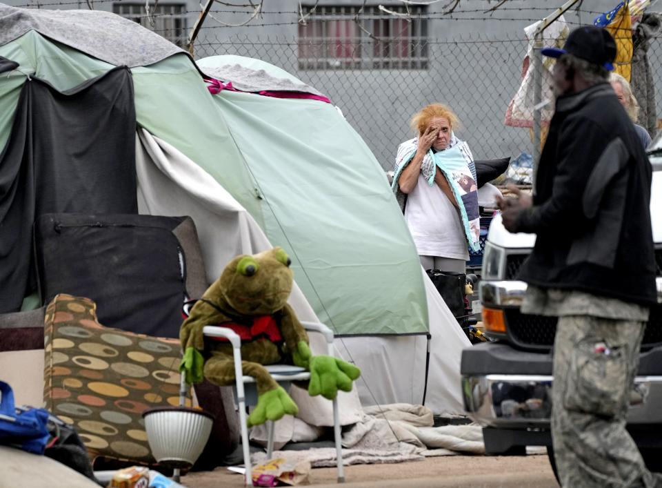 Vanessa Martin packs up her belongings as mandatory removal of "The Zone," a homeless camp in Phoenix, began on May 10, 2023.