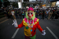 A pro-democracy activist dressed as a flown gustures during their march to the Government House, prime minister's office during a protest march in Bangkok, Thailand, Wednesday, Oct. 21, 2020. Thailand's prime minister on Wednesday pleaded with his countrymen to resolve their political differences through Parliament, as student-led protests seeking to bring his government down continued for an eighth straight day. (AP Photo/Sakchai Lalit)