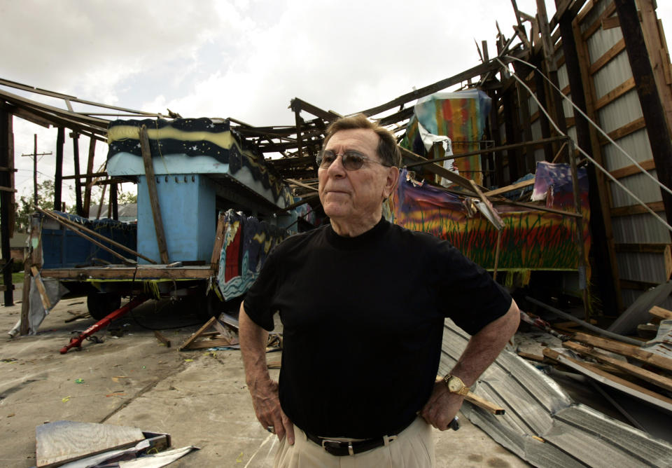 FILE - In this Sept. 29, 2005 file photo, Blaine Kern, Sr., also known as "Mr. Mardi Gras," looks over the damage by Hurricane Katrina to one of his warehouses at Mardi Gras World in New Orleans. The man known as “Mr. Mardi Gras" for helping to convert the annual pre-Lenten celebration into a giant event in New Orleans has died. News outlets report that Blaine Kern Sr. died Thursday, June 25, 2020. For decades, Kern's work helped boost New Orleans' Carnival. (AP Photo/Kevork Djansezian, File)