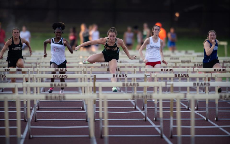 Forest Park's Rachel Mehringer, center, builds an insurmountable lead in the 100 meter hurdles during the IHSAA Girls Regional 8 Track & Field Meet at Central Stadium Tuesday evening, May 23, 2023. She took first in the event with a time of 13.75 seconds.