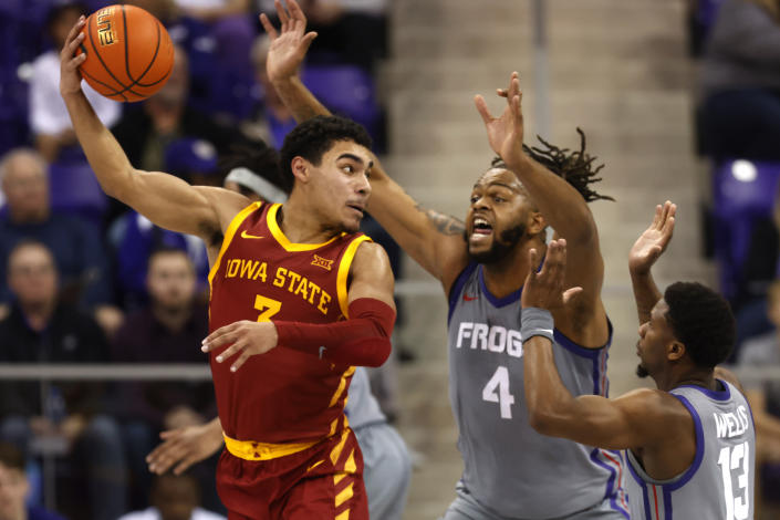 Iowa State guard Tamin Lipsey (3) passes the ball over TCU center Eddie Lampkin Jr. (4) and guard Shahada Wells (13) during the first half of an NCAA college basketball game, Saturday, Jan. 7, 2023, in Fort Worth, Texas. (AP Photo/Ron Jenkins)