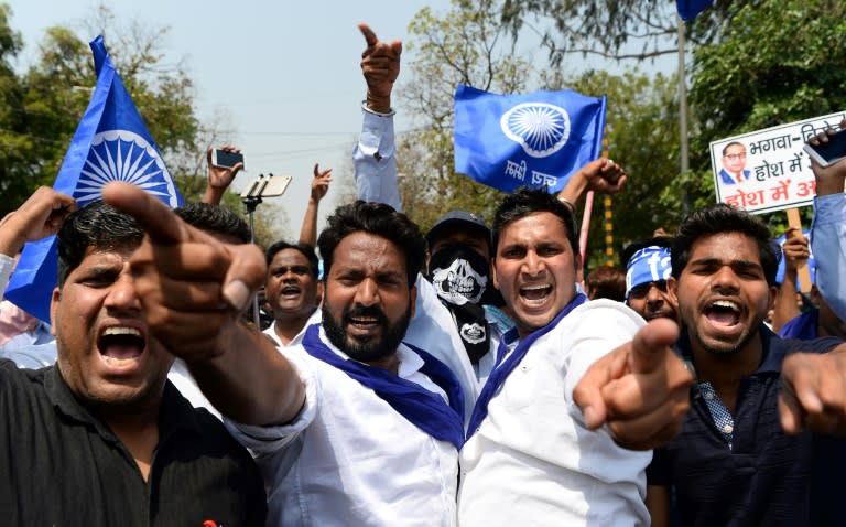 Indian members of the Scheduled Castes shout slogans during a protest against a Supreme Court order that they believe undermines a law protecting their safety