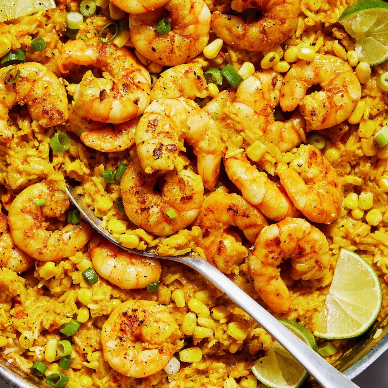 rice skillet topped with shrimp and sweet corn