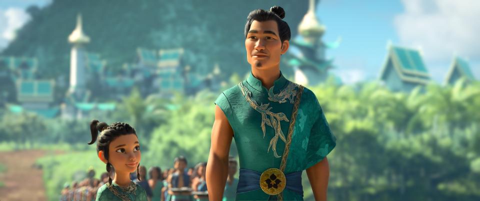 Animated character young Raya, left, appears with her father Benja, voiced by Daniel Dae Kim in a scene from "Raya and the Last Dragon." (Disney+ via AP)