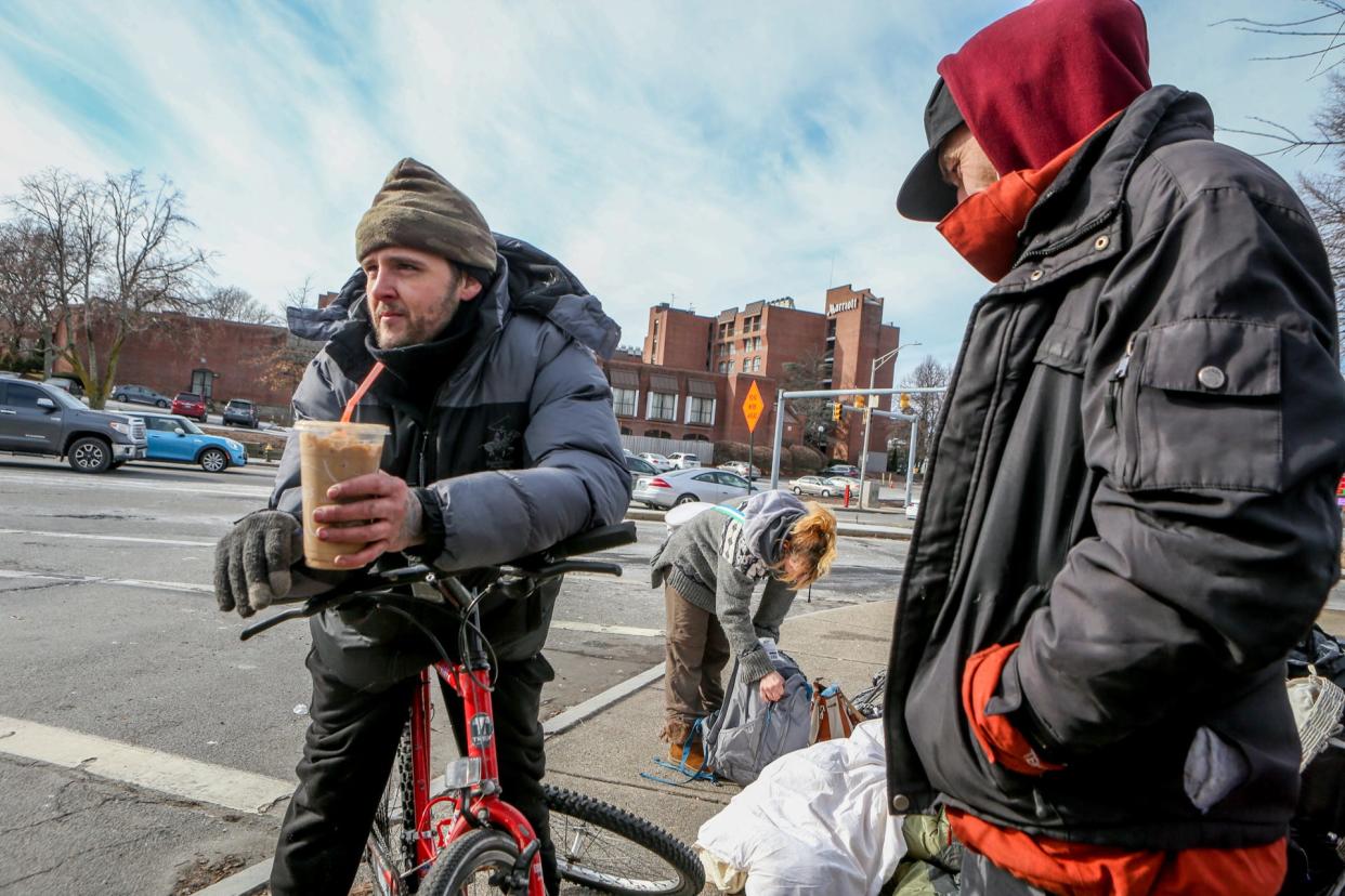 Several homeless people were evicted Friday from their encampment on the lawn at 1 Randall Square in Providence. Christopher Hughes, left, was returning to gather some things.