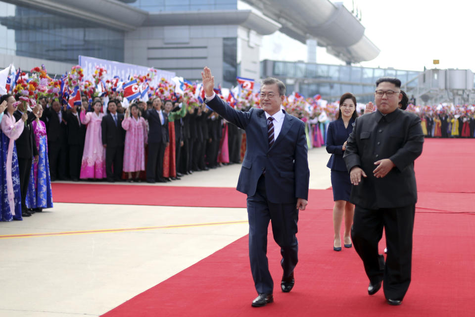 South Korean President Moon Jae-in and North Korean leader Kim Jong Un, right, attend a welcoming ceremony at Sunan International Airport in Pyongyang in North Korea, Tuesday, Sept. 18, 2018. (Pyongyang Press Corps Pool via AP)