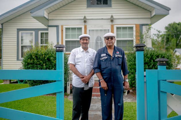 Brothers Byron, left, and Angelo Bernard pose outside a house in Reserve, Louisiana, part of what's known as 