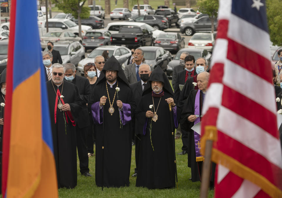 Religious leaders and others attend a ceremony remembering the victims of the Armenian Genocide at the Montebello Armenian Genocide Monument in Montebello, Calif., Saturday, April 24, 2021. The United States is formally recognizing that the systematic killing and deportation of hundreds of thousands of Armenians by Ottoman Empire forces in the early 20th century was "genocide" as President Joe Biden used that precise word that the White House has avoided for decades for fear of alienating ally Turkey. (AP Photo/Damian Dovarganes)