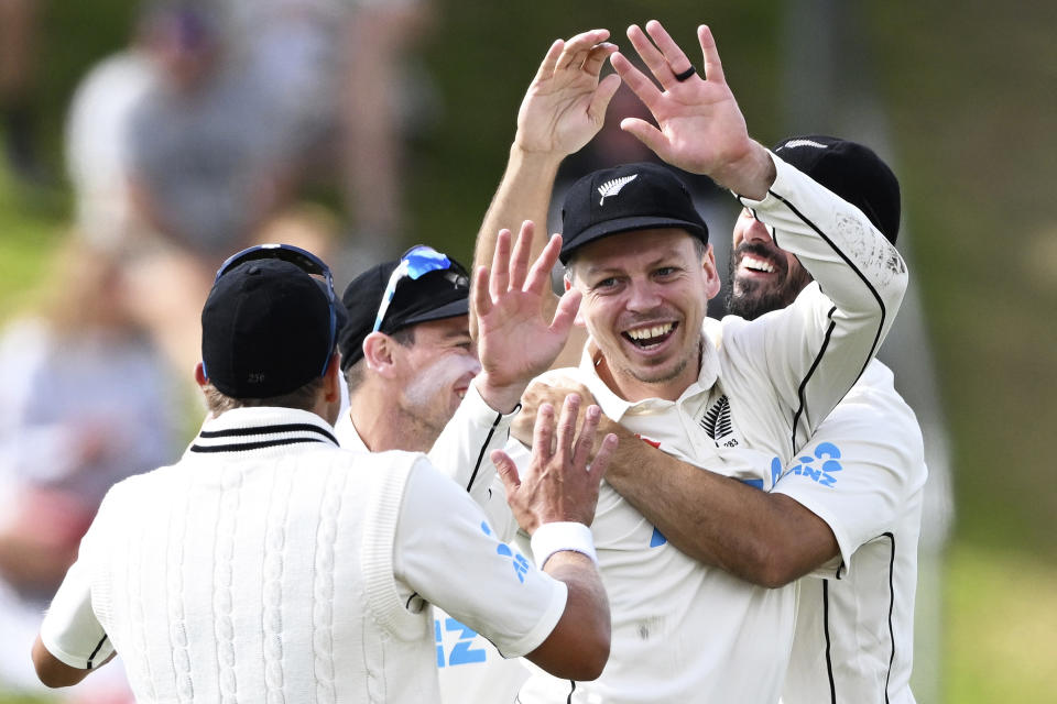 New Zealand's Michael Bracewell, center, celebrates with teammates after the wicket of England's Harry Brook on day 5 of their cricket test match in Wellington, New Zealand, Tuesday, Feb 28, 2023. (Andrew Cornaga/Photosport via AP)