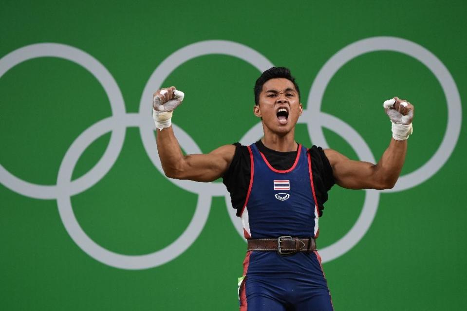 Sinphet Kruaithong celebrates after becoming the first male Thai weightlifter to medal at the Olympics. (AFP)