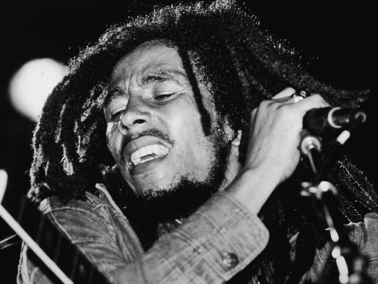 Jamaican reggae musician Bob Marley performs on stage, a microphone in his hand, late 1970s: Getty Images