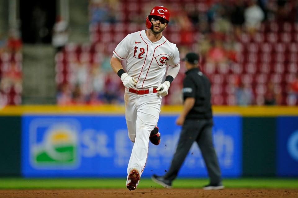 Cincinnati Reds right fielder Tyler Naquin (12) runs the bases on a solo home run in the eighth inning of the MLB National League game between the Cincinnati Reds and the Chicago Cubs at Great American Ball Park in downtown Cincinnati on Tuesday, May 24, 2022. The Cubs won 11-4. 