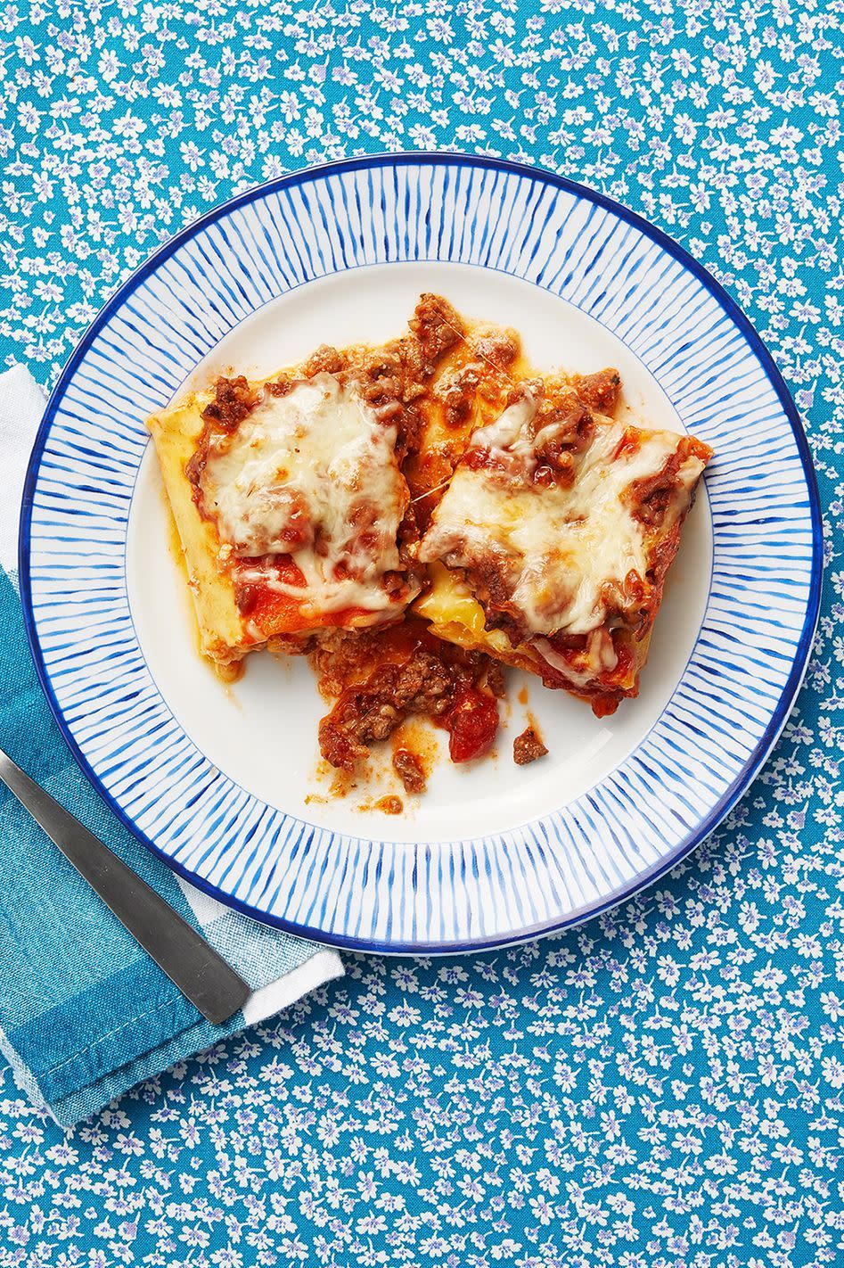 lasagna roll ups on blue and white plate