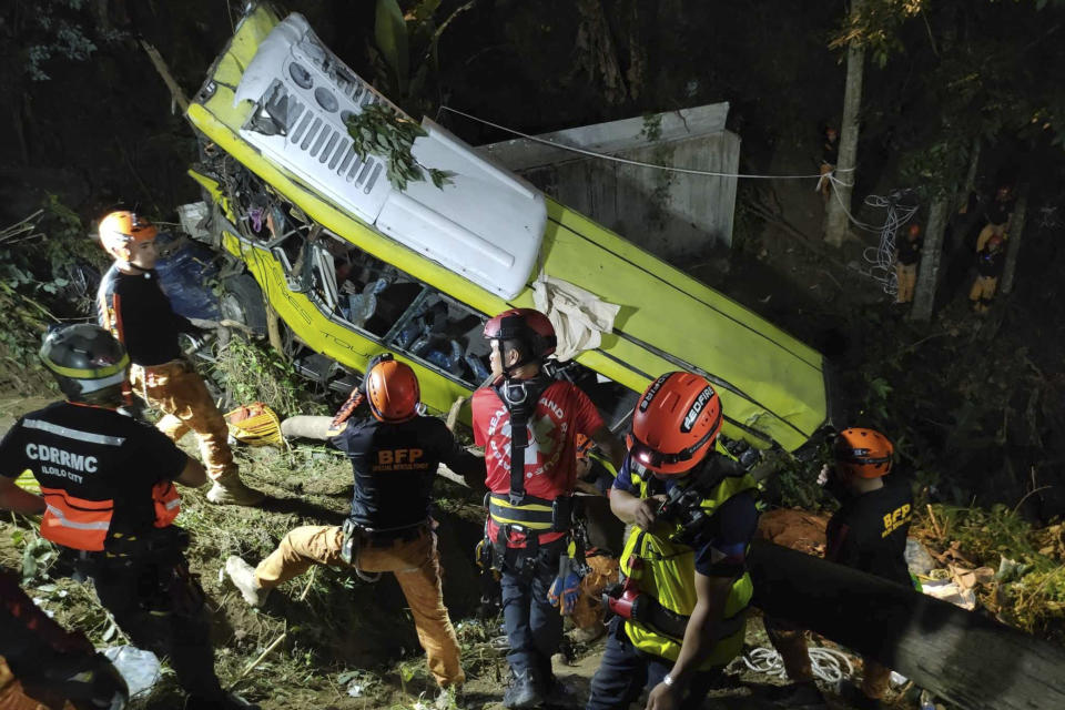 In this photo provided by the Iloilo City Disaster Risk Reduction and Management Office - Urban Search and Rescue Unit, rescuers retrieve bodies from a damaged passenger bus in a ravine at the mountainous Hamtic town, Antique province, central Philippines early Wednesday Dec. 6, 2023. The passenger bus lost control while negotiating a downhill curve and plunged into a deep ravine Tuesday afternoon killing some passengers and injuring others officials said. (Iloilo City Disaster Risk Reduction and Management Office - Urban Search and Rescue Unit via AP)