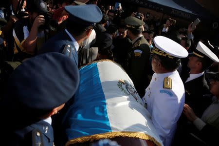 Guatemalan military officers carry the coffin containing the body of former Guatemalan military dictator Efrain Rios Montt, during his funeral at the cemetery in Guatemala City, April 1, 2018. REUTERS/Luis Echeverria