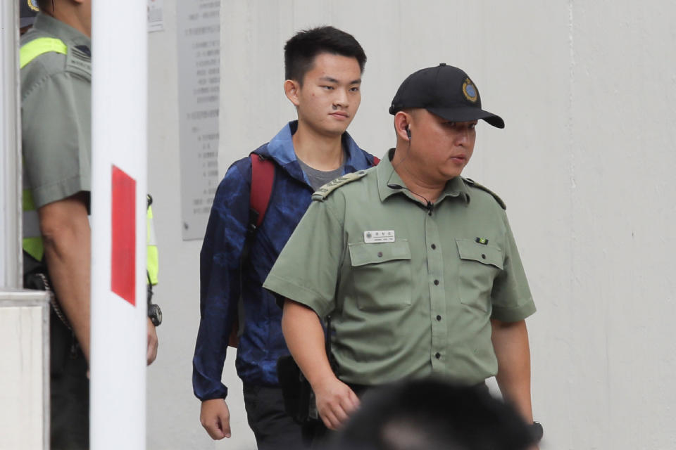 Chan Tong-kai, center, walks as he is released from prison in Hong Kong Wednesday, Oct. 23, 2019. Chan, who's wanted for killing his girlfriend last year on the self-ruled island, had asked the Hong Kong government for help turning himself in to Taiwan after his sentence for money laundering offenses ends on Wednesday. (AP Photo/Kin Cheung)