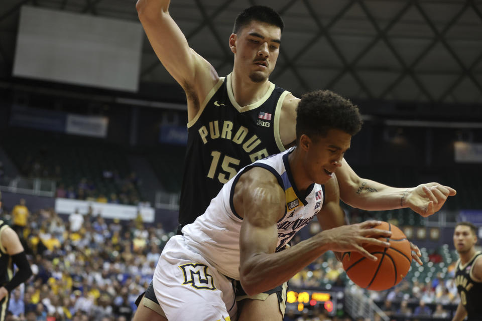 Purdue center Zach Edey (15) guards Marquette forward Oso Ighodaro during the first half of an NCAA college basketball game, Wednesday, Nov. 22, 2023, in Honolulu. (AP Photo/Marco Garcia)