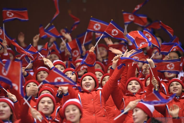 The 200-strong group -- all in their late teens or early 20s and said to be handpicked from elite universities after strict background checks -- chant "Cheer up" at events, clap and wave in unison, and sing traditional songs