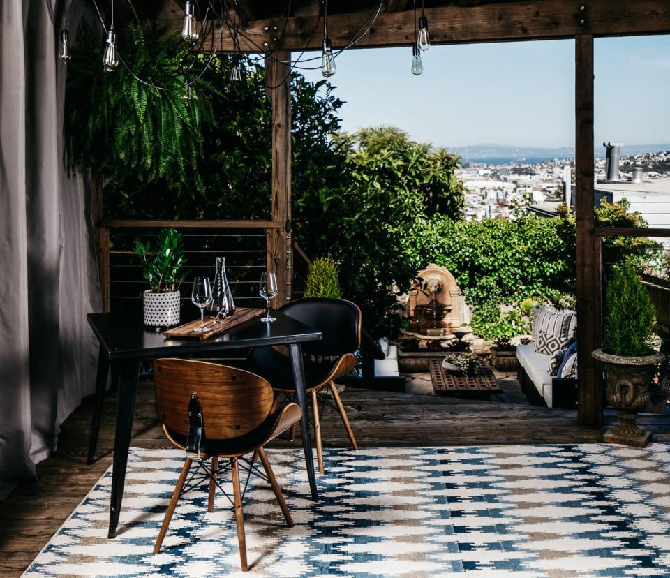 <p>A covered terrace in San Francisco takes inspiration from the iconic style, with mid-century modern chairs and a summery, patterned rug.</p><p><em>Design by <a href="https://deringhall.com/interior-designers/deniece-duscheone-inc" rel="nofollow noopener" target="_blank" data-ylk="slk:Deniece Duscheone Inc." class="link ">Deniece Duscheone Inc.</a></em></p>