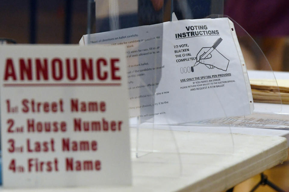 Instructions for voting are posted at a polling location on primary election day, Tuesday, Aug. 9, 2022, in Suffield, Conn. Suffield is one of several small towns in Connecticut where control was flipped from Democrats to Republicans in 2021 municipal races. (AP Photo/Jessica Hill)