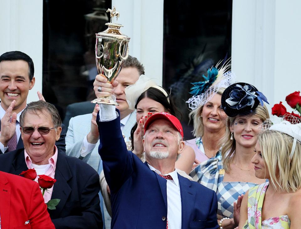 Owner Rick Dawson celebrates with the trophy after Rich Strike wins the 148th running of the Kentucky Derby at Churchill Downs on Saturday in Louisville, Ky.