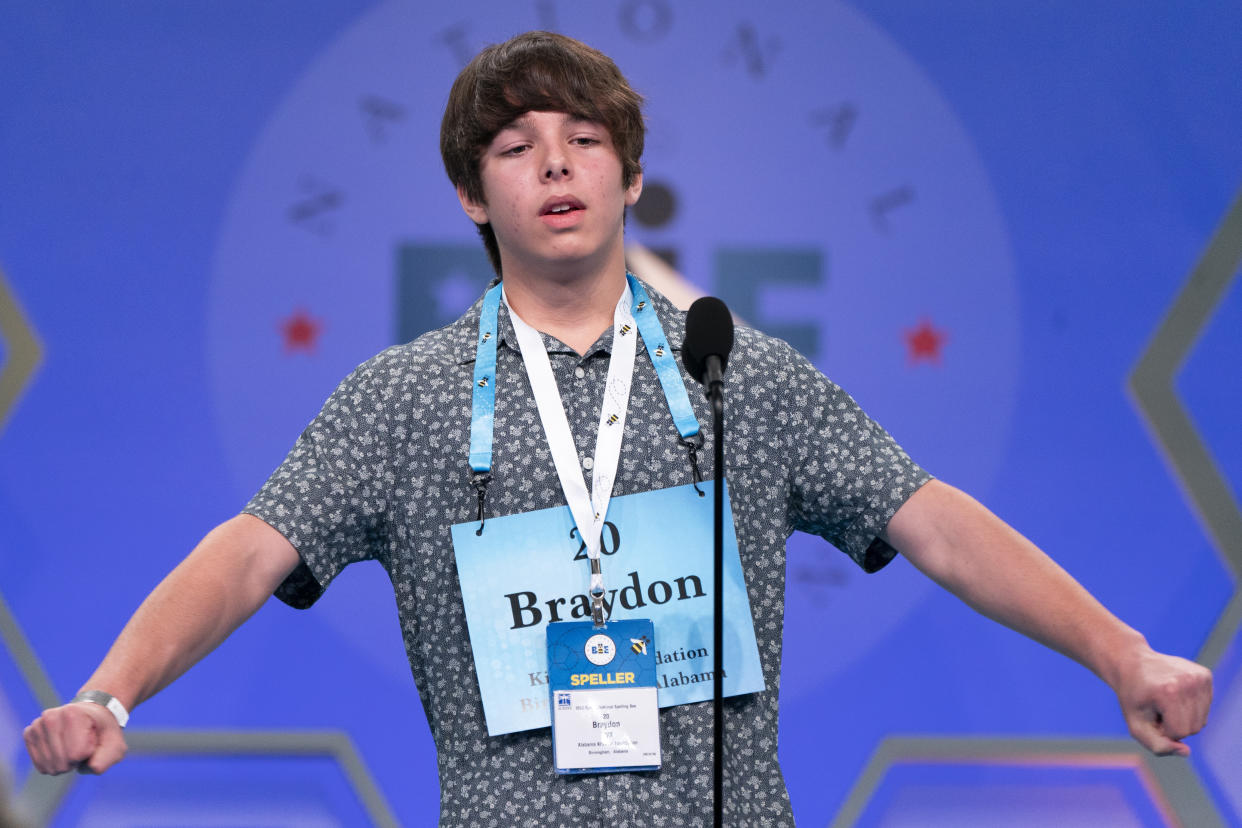 Braydon Syx, 13, stretches with relief on spelling a second word correctly, during the Scripps National Spelling Bee, in Oxon Hill, Md., Tuesday, May 31, 2022. (AP Photo/Jacquelyn Martin)