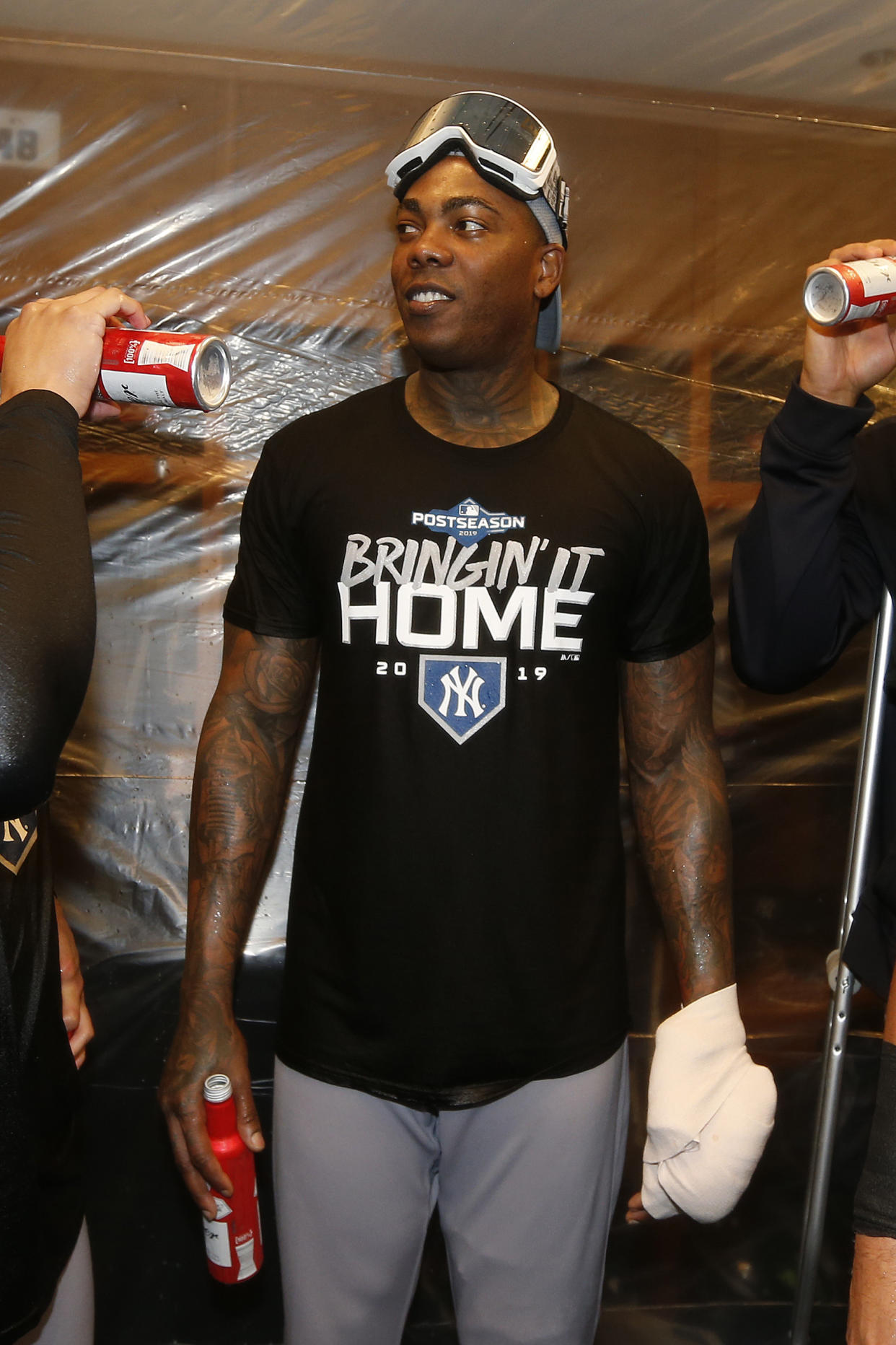Aroldis Chapman's pitching hand was in a heavy wrap after he says he was hit with a bottle in the clubhouse. (Getty)