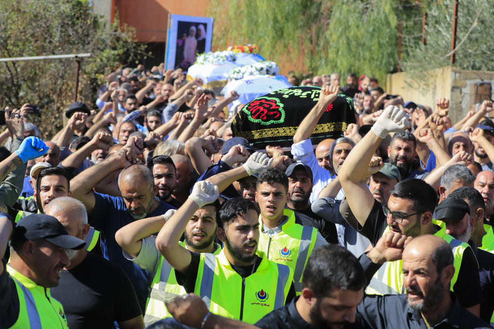 People carry the coffins of the victims who were killed by an Israeli airstrike, chant slogans during their funeral procession in the town of Blida, a Lebanese border village with Israel in south Lebanon, Tuesday, Nov. 7, 2023. A Lebanese woman and her three grand daughters were laid to rest in their hometown in southern Lebanon two days after they were killed in an Israeli drone strike while in a car near the Lebanon-Israel border. (AP Photo/Mohammed Zaatari)