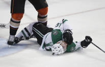 Dallas Stars' Ryan Garbutt falls to the ice after he was checked by Anaheim Ducks' Bryan Allen during the third period in Game 1 of the first-round NHL hockey Stanley Cup playoff series on Wednesday, April 16, 2014, in Anaheim, Calif. The Ducks won 4-3. (AP Photo/Jae C. Hong)