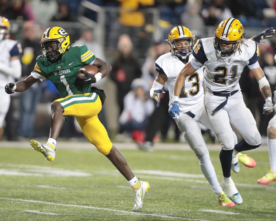 St Edward's Kyan Mason breaks free from Springfield defenders Tyrone Myers 13, and Teryon Holt, 21, to score in in the first half during the Division I state championship game at Tom Benson Hall of Fame Stadium in Canton, Friday, Dec. 2, 2022.