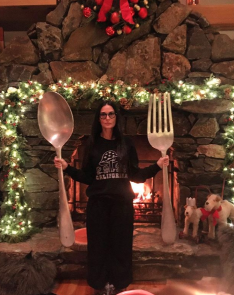 Demi Moore poses with giant fork and spoon