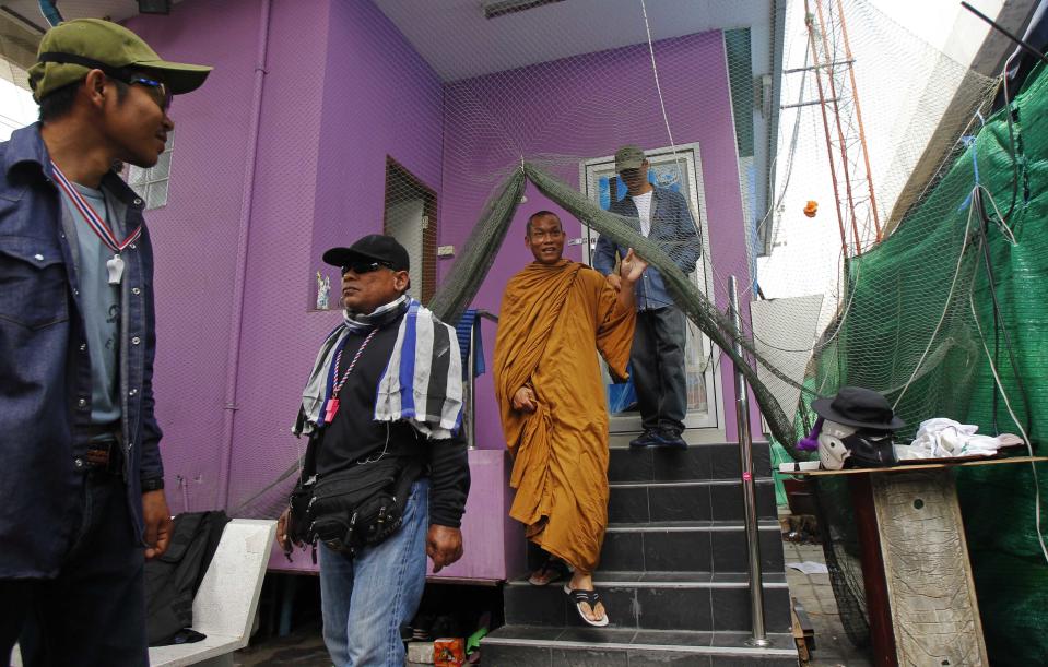 Thai Buddhist monk and protest leader Luang Pu Buddha Issara walks at a protest site during a rally in Bangkok