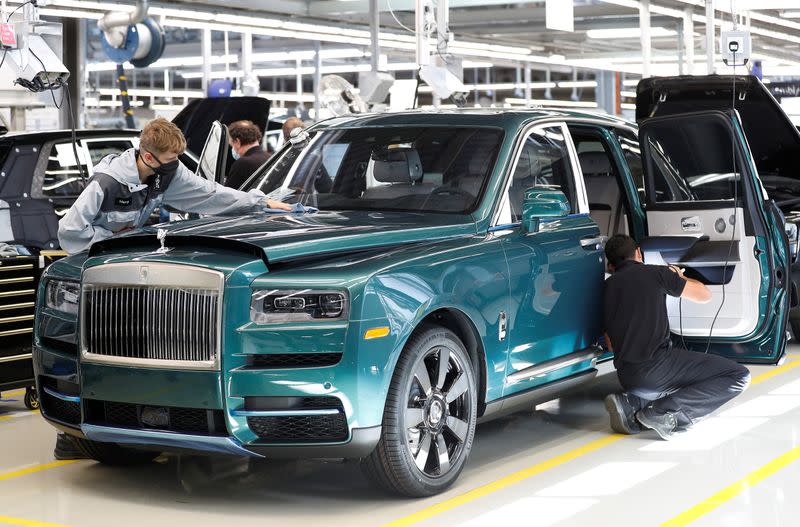 Technicians inspect a Rolls-Royce a car on the production line of the Rolls-Royce Goodwood factory, near Chichester