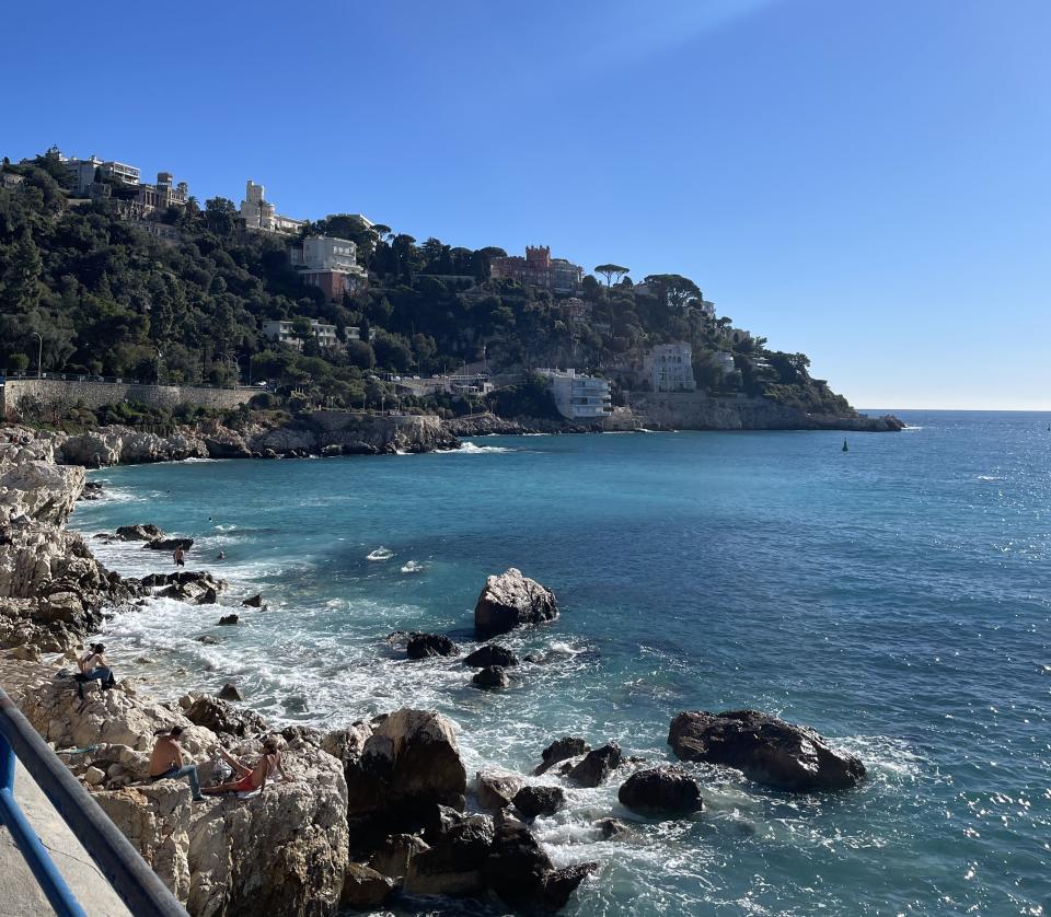 Aside from the main beaches in Nice, there are other areas where people prefer to sit out, like on the rocky outcrops pictured above on Nov. 11, 2023. | Asia Bown
