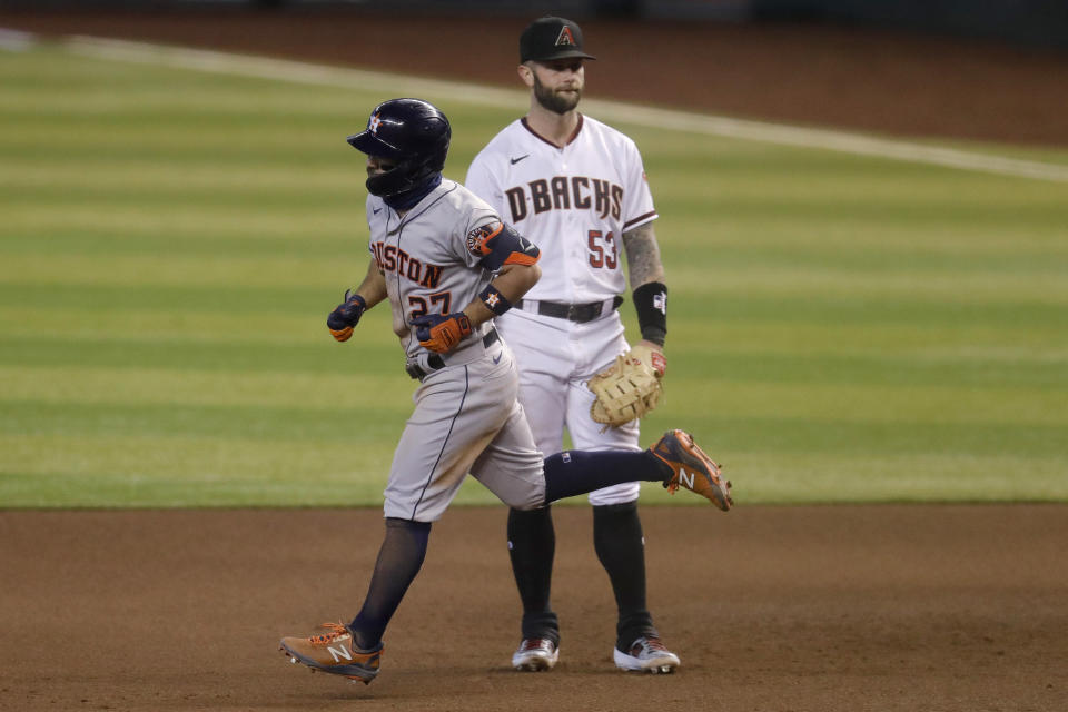 Houston Astros' Jose Altuve passes Arizona Diamondbacks' Christian Walker (53) after hitting a solo home run during the sixth inning of a baseball game Thursday, Aug. 6, 2020, in Phoenix. (AP Photo/Matt York)