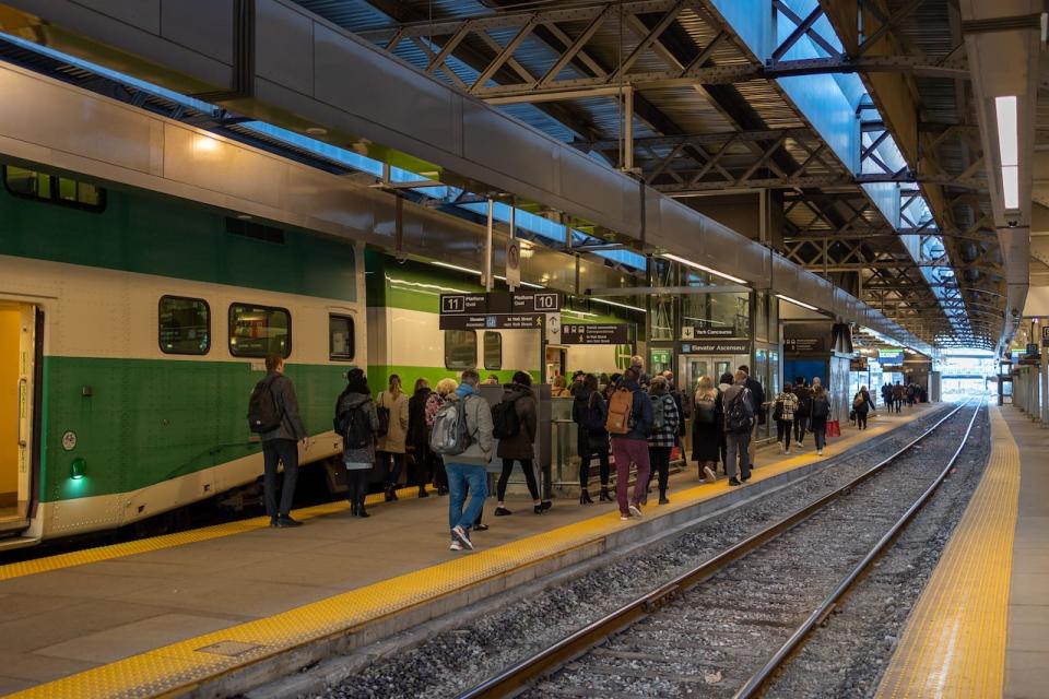 Commuters arrive at Union Station from the GO train in Toronto, April 20, 2022. THE CANADIAN PRESS/Yader Guzman